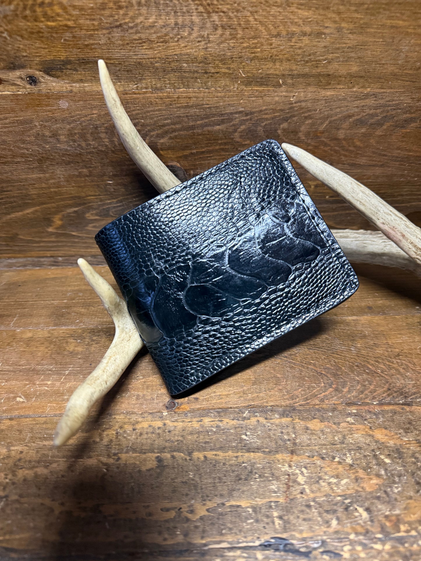 Black ostrich leg skin bifold wallet