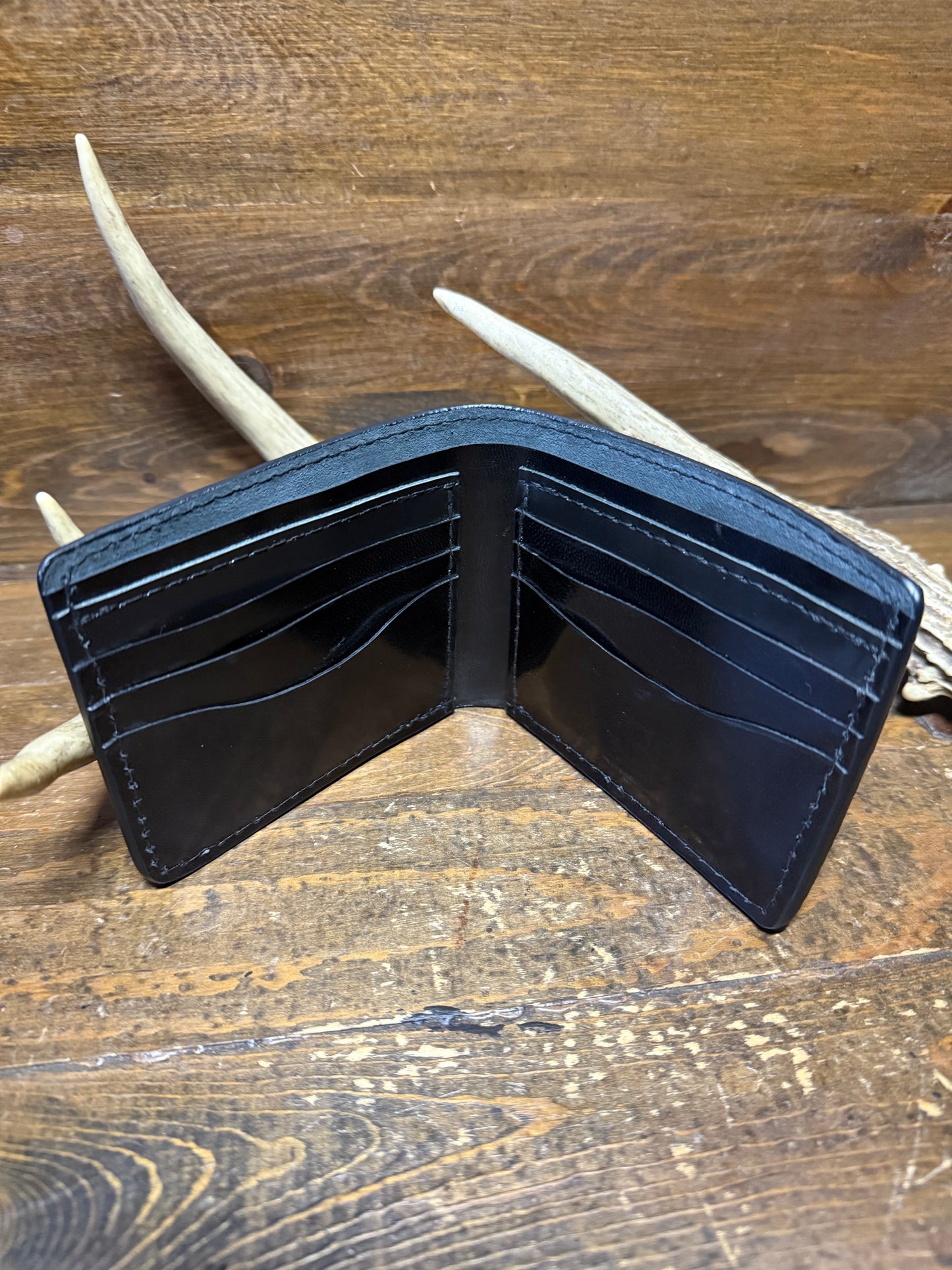 Black ostrich leg skin bifold wallet